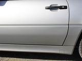 a silver car that is parked on the side of the road