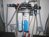 a picture of a water filtrator with hoses connected to it