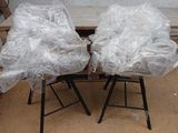 two chairs that are covered with plastic bags on them