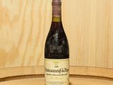 une bouteille de vin posée sur un tonneau