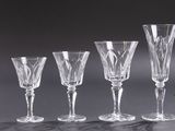 six wine glasses are lined up in a row on a table