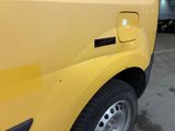 a close up of a yellow truck parked in a parking lot