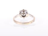 a close up of a ring with a flower on top of it
