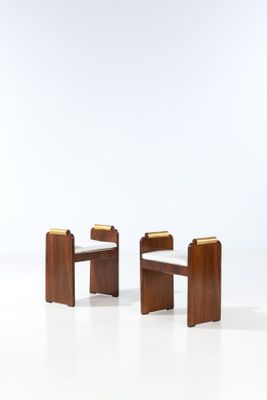 two wooden chairs with glass tops on a white surface