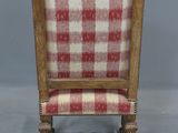 a wooden chair with a red and white checkered upholstered seat