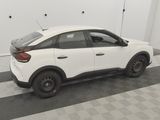 the rear end of a white car parked in a garage