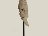 an image of a statue of a man with a knife on a stand