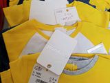 a lot of t - shirts that have tags on them