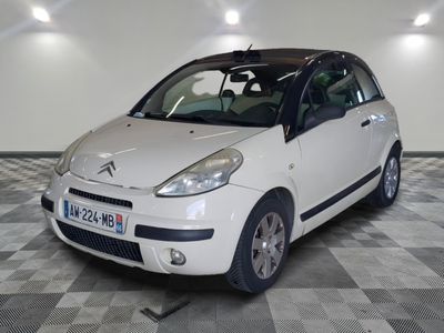 a picture of a small white car parked in a garage