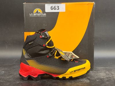 the black and yellow shoe is next to a box of money
