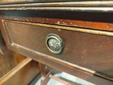 a close up of a wooden desk with a drawer on it