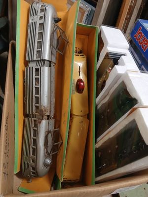 a box with a train model in it sitting on the floor