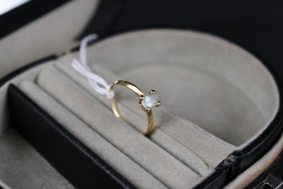 a ring in a box with a white string