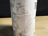 a can of yogurt sitting on a table with a black background