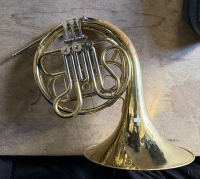 a brass instrument that is laying on a table