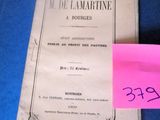 an old book with a pink sticker on it sitting on a blue surface