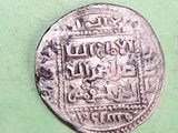 a close up of a silver coin on a green surface
