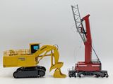 two toy vehicles that are next to each other on a white surface