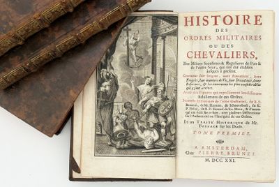 an old book that is open on a white surface