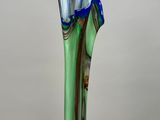 a glass vase with a green and blue design on it