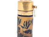 a gold and black vase with a bird on it