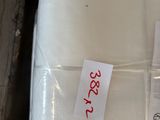 a white pillow on a pallet with a price tag on it