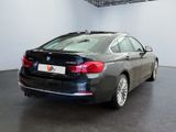 the back of a bmw 6 series sedan parked in a showroom