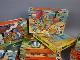 several children ' s board games are stacked on top of each other