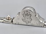 an antique silver plated plane with a handle on a white surface