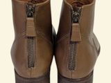 pair of brown leather boots with zippers on the side