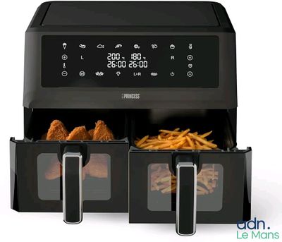 a close up of an air fryer with french fries in it