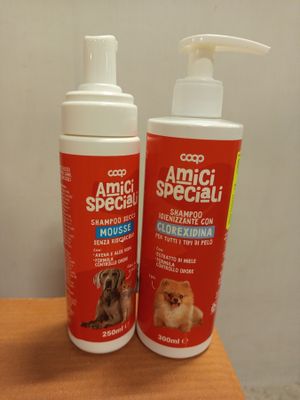 two bottles of dog sham sitting on top of a wooden table