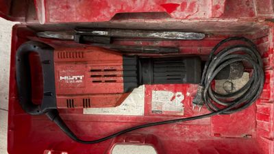 une perceuse dans une boîte rouge avec un cordon