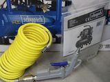 a yellow hose and a blue air compressor in a box