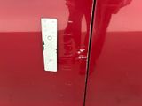a close up of a door handle on a red car