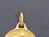 an image of a gold medal with a woman and child on it