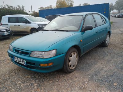 a blue car that is parked in a parking lot