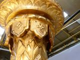 a gold statue that is on display in a museum