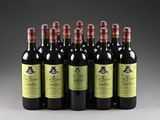 six bottles of wine are lined up in a row on a gray surface