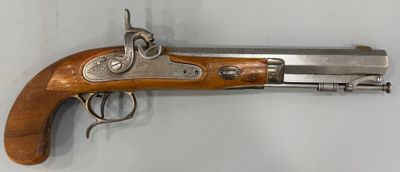 un gros plan d'un pistolet accroché au mur, sur fond blanc
