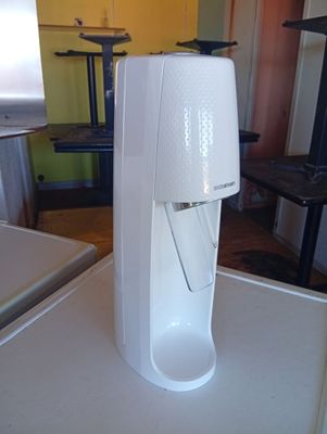 a white water dispenser on a counter in a kitchen