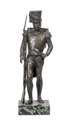 bronze statue of a soldier with a rifle on a marble base