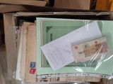 a box full of mails and other papers on the floor