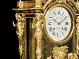 a gold clock that is sitting on a table