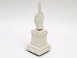 a white statue of a hand with a finger on top of it