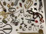many different types of necklaces and bracelets displayed on a table