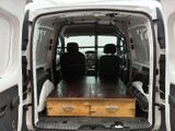 a white van with a wooden table in the back of it