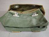 a green purse with two silver buttons on it