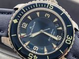 a close up of a watch with a black face