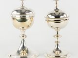 a pair of silverplated goblets with a cross on the top
